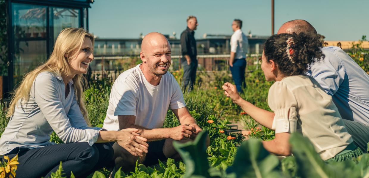 People interacting in the garden at Østergro