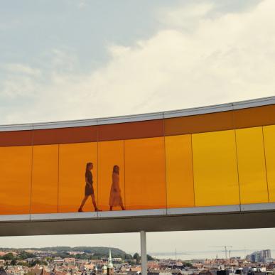 Two people walking in Your rainbow panorama, ARoS Aarhus Art Museum