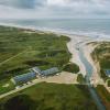 A drone view of Henne Mølle Å hotel, a beach hotel on the west coast of Denmark