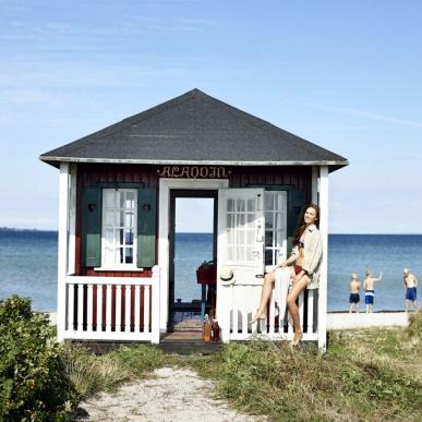 A lady sits at a beach house on Ærøskøbing Beach, Ærø, Denmark