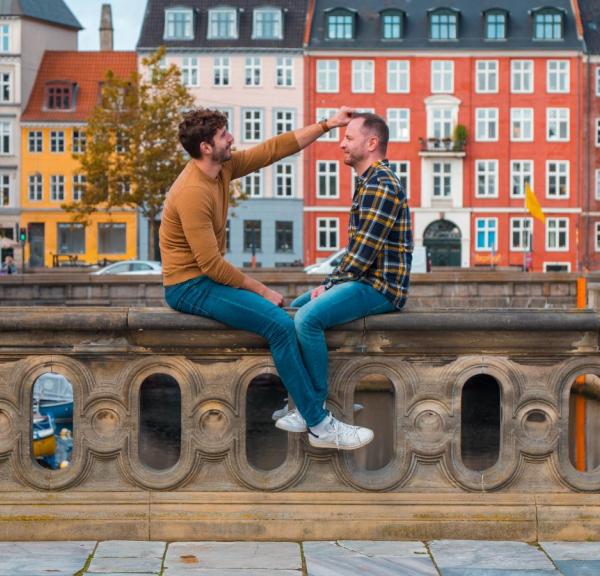 Gay couple sits at the canals in Copenhagen