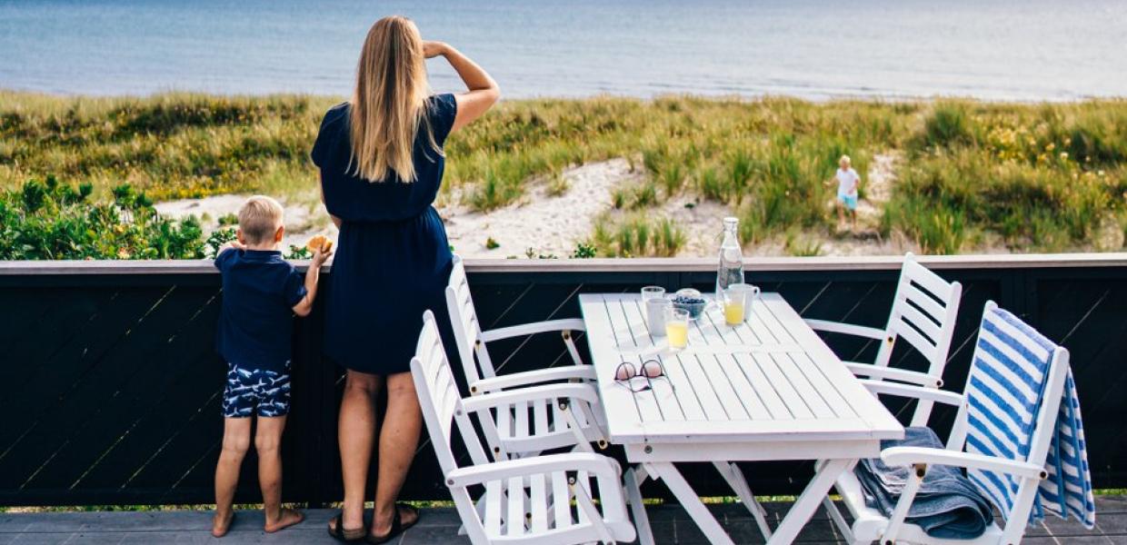A mother and child looking at the water from a summer house on Djurland in East Jutland.