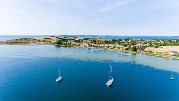 Sailing boats on the blue water around Fyn. 