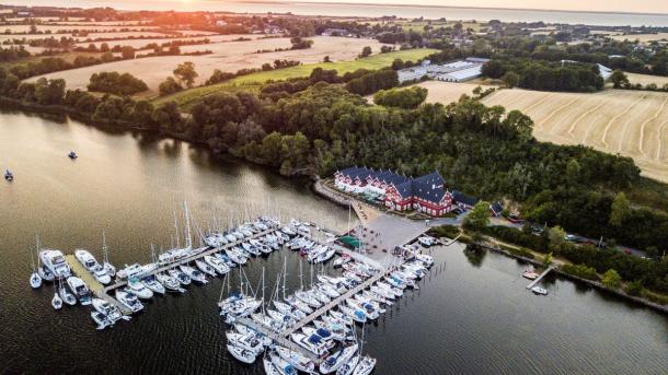 A view of Dyvig Badehotel from the air, showing a nearby marina and the Danish boutique hotel itself