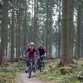 A couple go mountain biking in Silkeborg, Jutland, Denmark