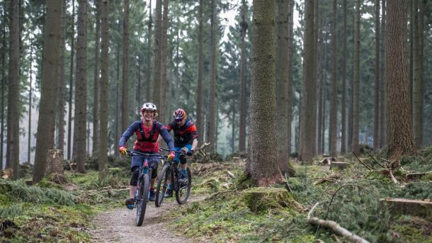 A couple go mountain biking in Silkeborg, Jutland, Denmark