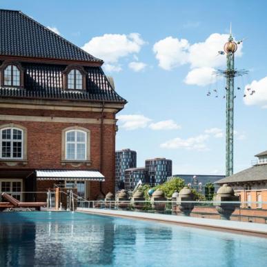 The outdoor pool at Villa Copenhagen with Tivoli Gardens in the background