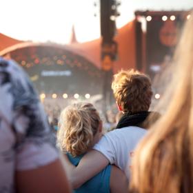 Couple in front of Orange Stage at Roskilde Festival