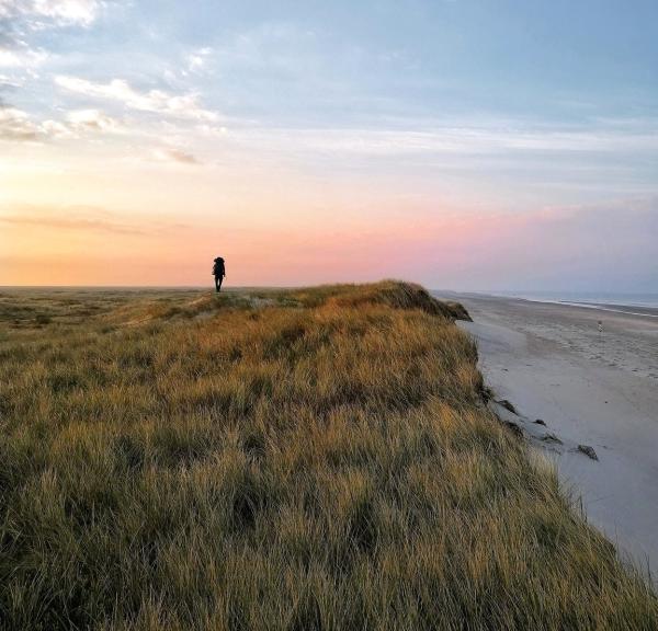 A person hiking along Skallingen on the West coast.