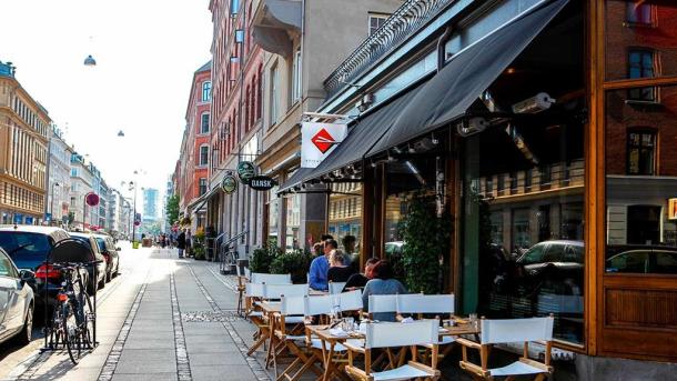 People eating on the street at Sticks'n'Sushi on Istegade, Copenhagen, Denmark