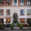 People sitting outside the winebar Pompette, a bar in central Copenhagen, Denmark